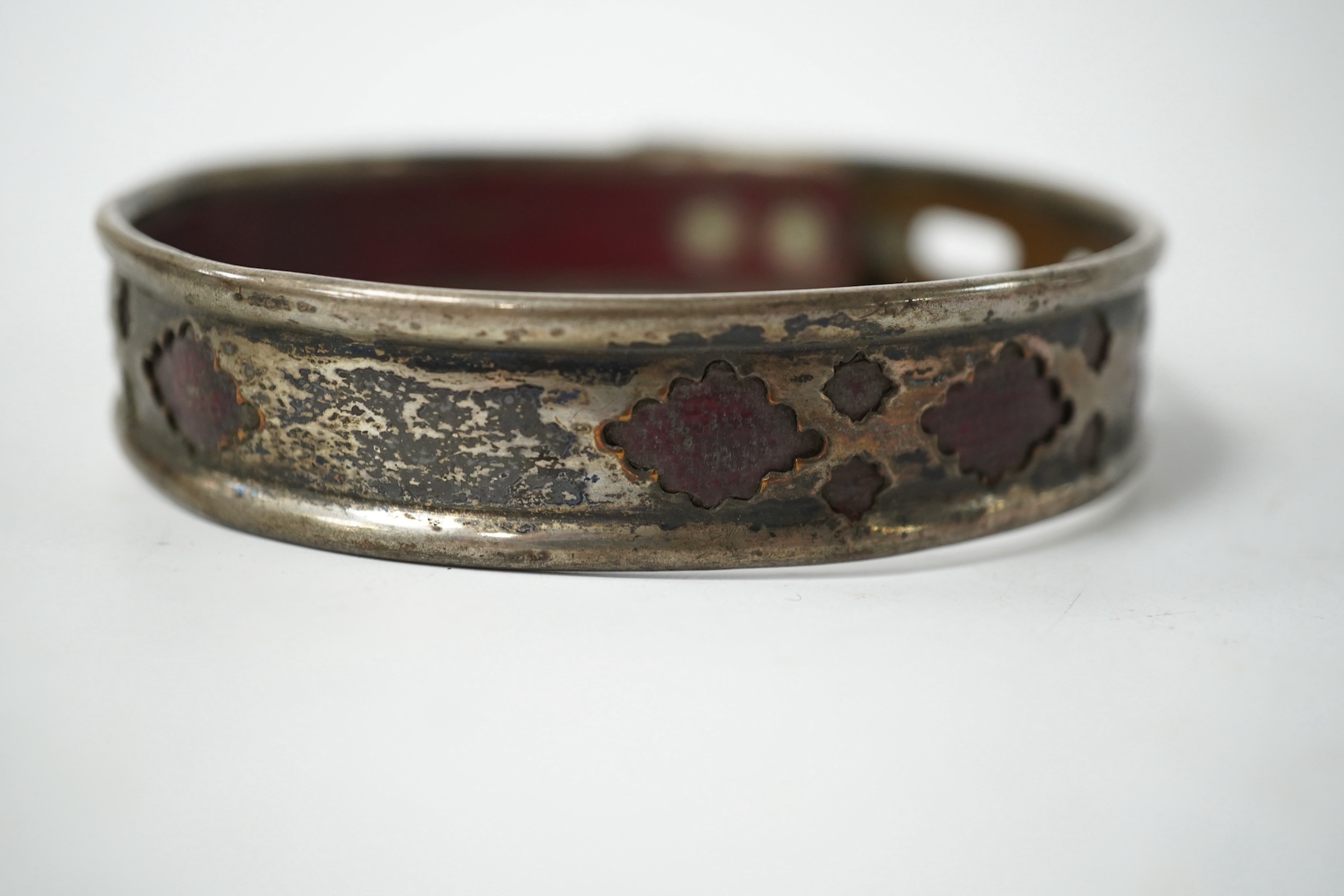 An 18th century Old Sheffield Plate and leather dog collar, 8.5cm in diameter. Condition - fair